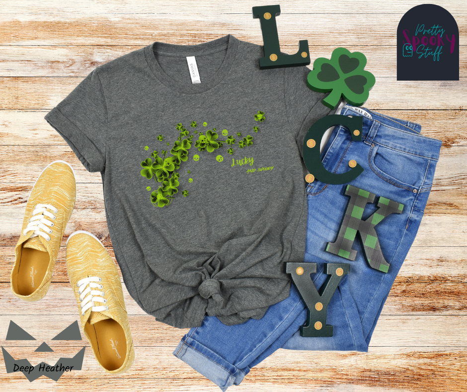 St. Patrick's Day shirt with green clovers and green skulls around them and on top of them with the words "lucky and spooky" below, in deep heather.