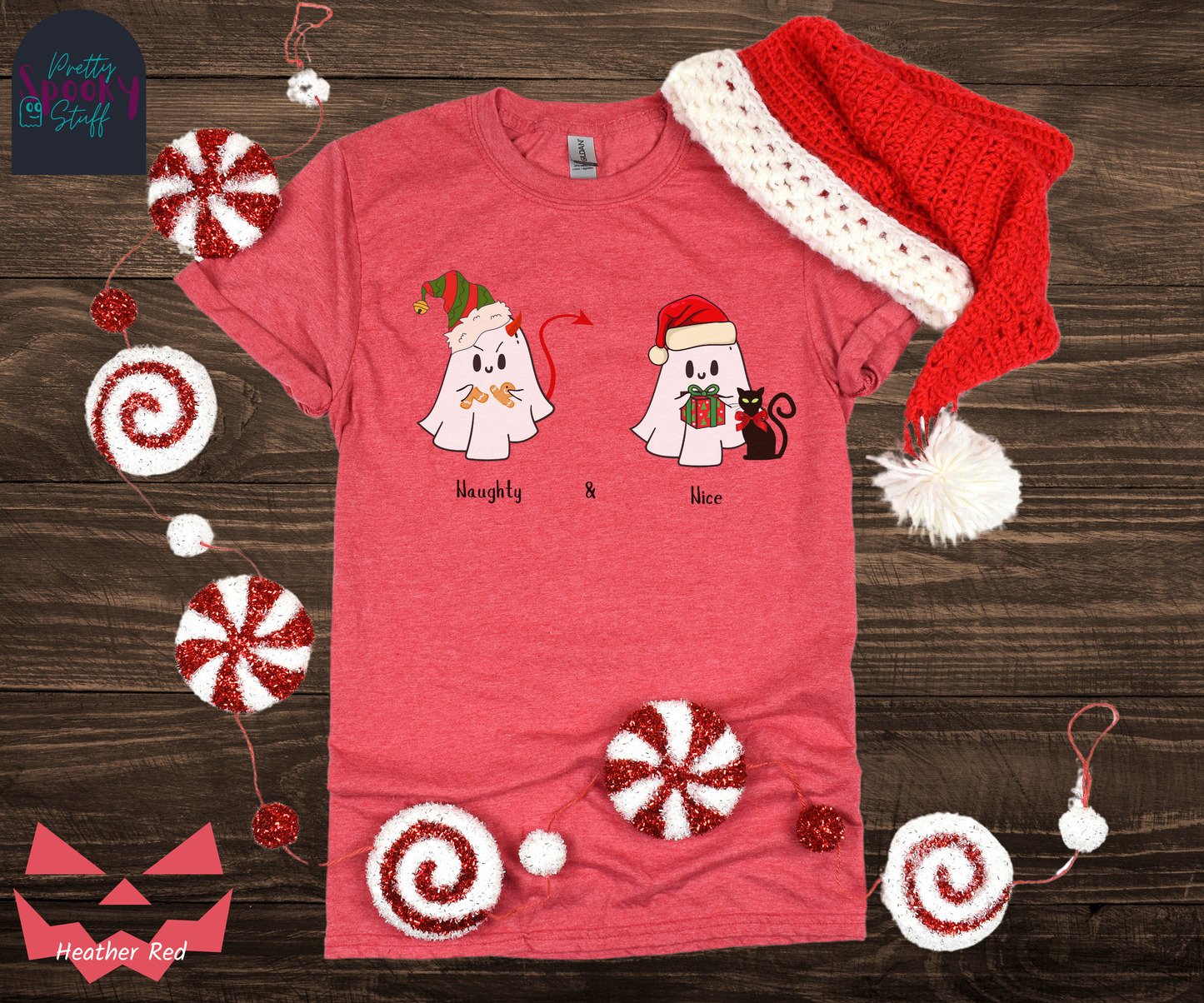 Christmas shirt with two ghosts wearing Santa hats, one named Naughty with a devil's tail and horn breaking a gingerbread man, and one named Nice holding a wrapped gift with a bow-wearing black cat next to them, in heather red.