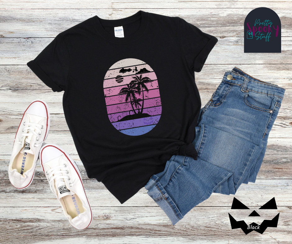 Summerween shirt with oval purple gradient lines, behind small beach and palm trees silhouette, that also has three gravestones on the beach with several ghosts flying above, as well as a witch flying on her broom in the clouds, in black.