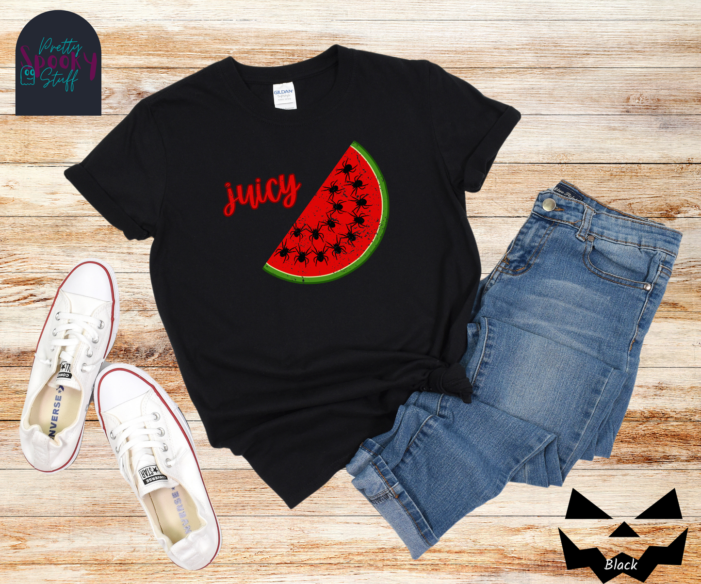 Summer watermelon shirt with a slice of watermelon where black spiders replace seeds, and the word "juicy" in red cursive font, vintage look, in black.