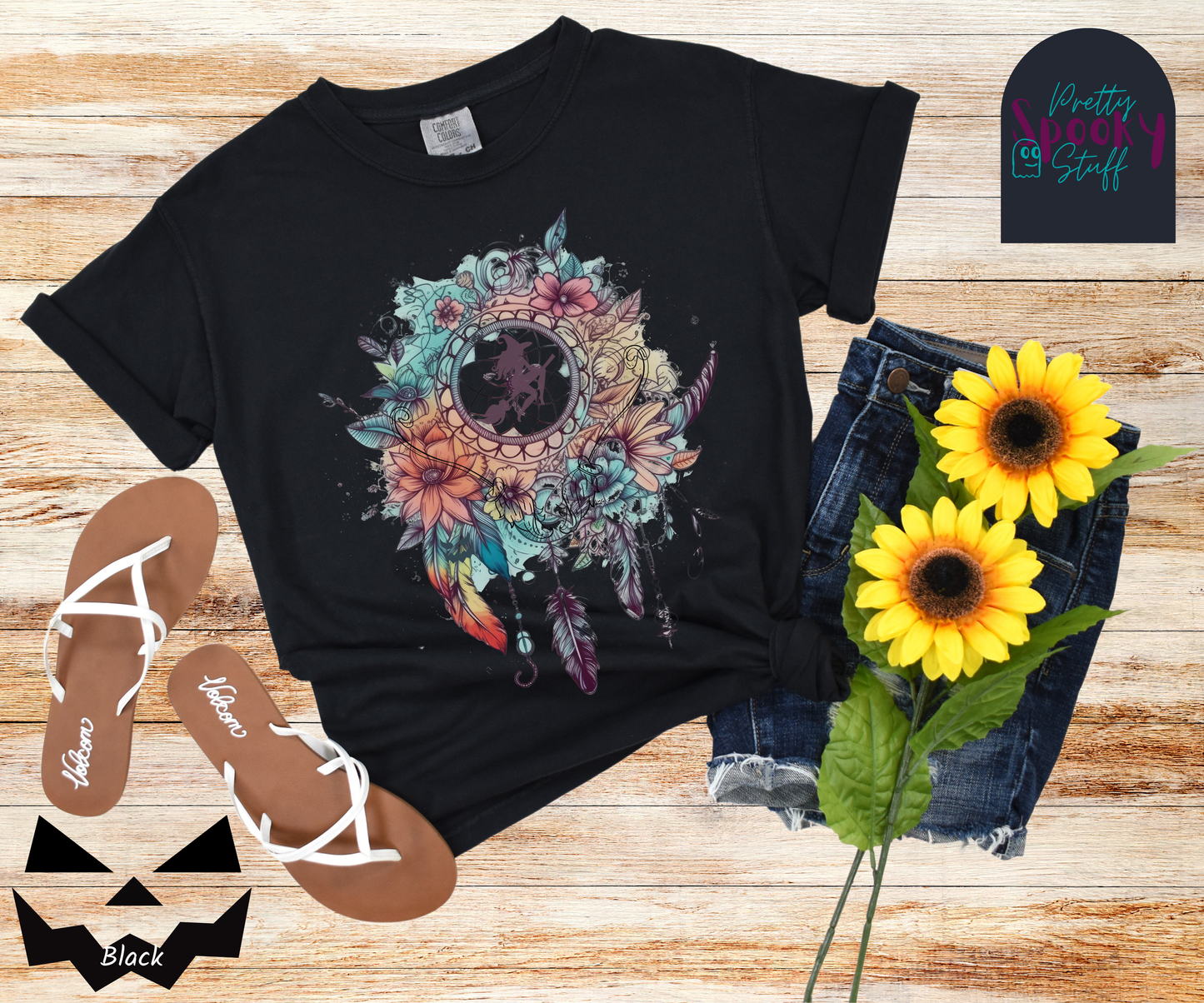 Halloween floral witch dreamcatcher shirt, watercolor aesthetic in blues and pinks, with purple silhouette of witch flying on her broom in the main circle, with witch broom line drawings hidden amongst the flowers, in black.