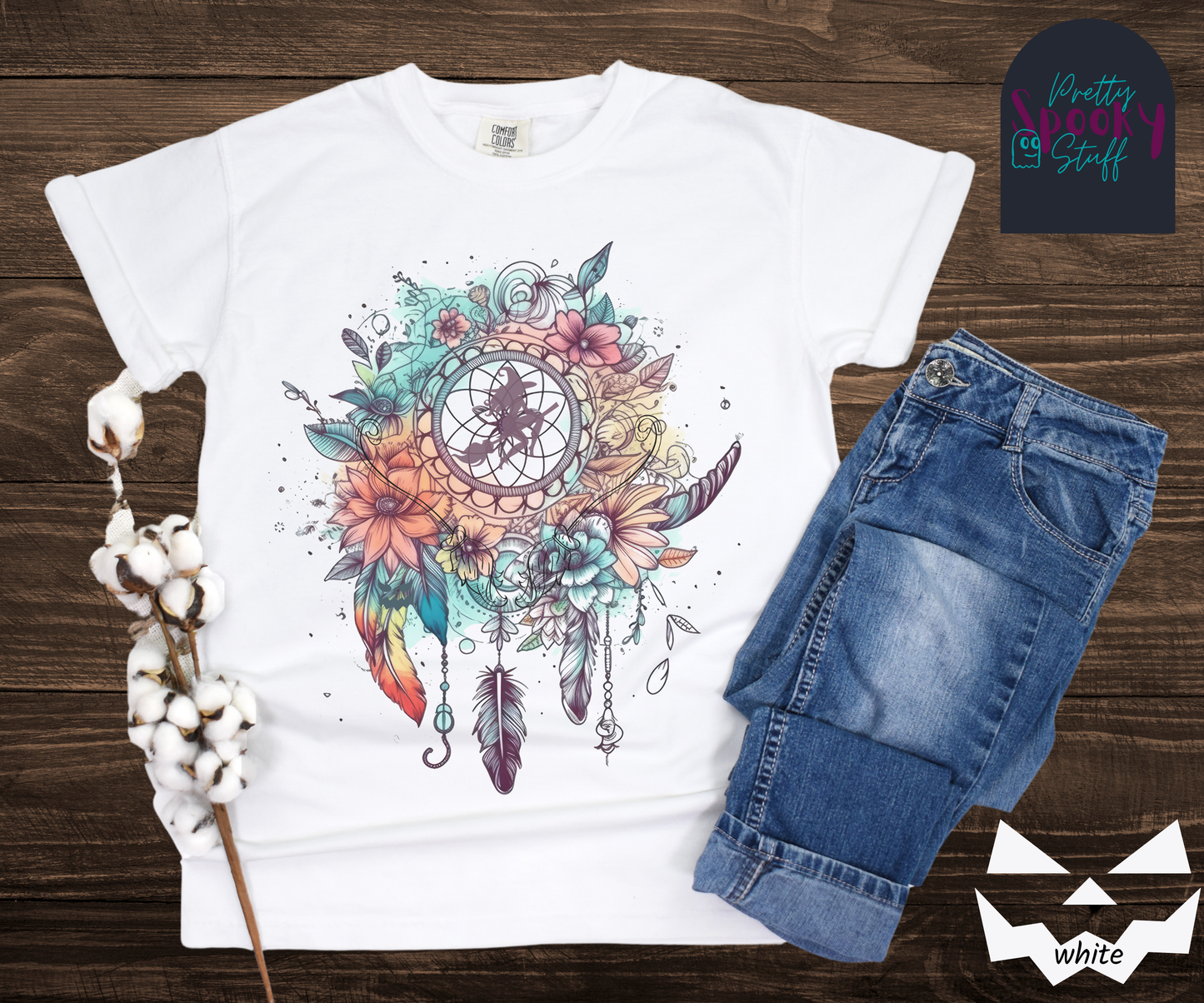 Halloween floral witch dreamcatcher shirt, watercolor aesthetic in blues and pinks, with purple silhouette of witch flying on her broom in the main circle, with witch broom line drawings hidden amongst the flowers, in white.