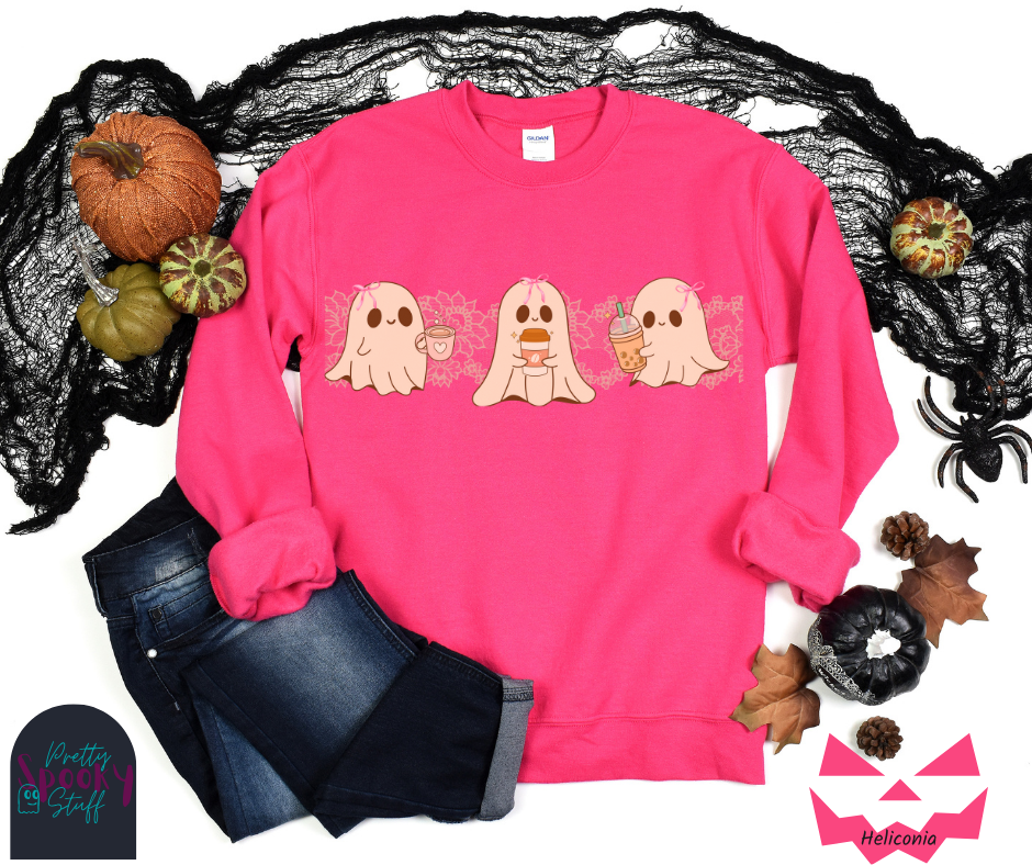Coquette Halloween sweatshirt with three adorable ghosts, each enjoying their own coffee beverage, adorned with a pink bow, with light pink intricate lace design behind them, in heliconia.