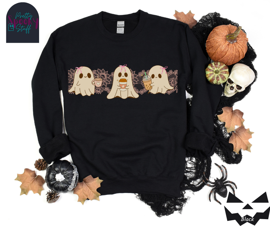 Coquette Halloween sweatshirt with three adorable ghosts, each enjoying their own coffee beverage, adorned with a pink bow, with light pink intricate lace design behind them, in black.