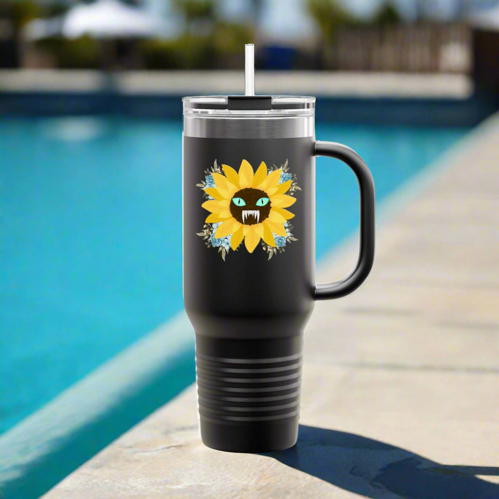 Spooky Girl Summer 40oz tumbler design featuring a sunflower with a menacing face in the middle(striking blue eyes and sharp teeth), with light blue florals in each corner, black background. Sitting by the pool.