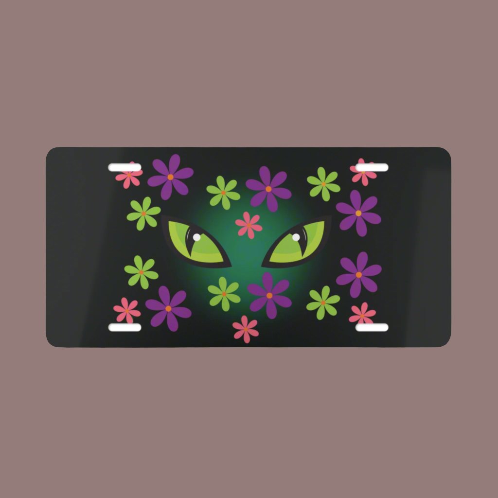 Cat Halloween vanity plate with spooky green cat eyes in the middle of purple, pink and green flowers, with a blue glow behind them, black background.