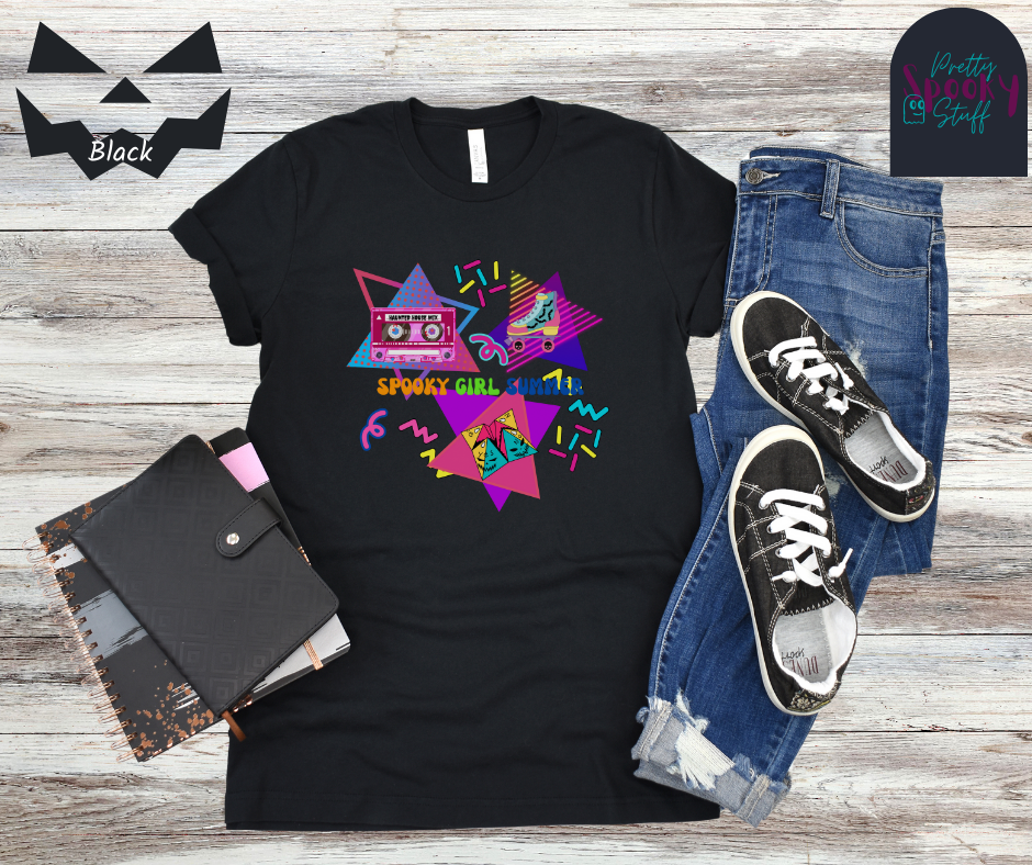 Summerween unisex tee featuring retro 90's design including cassette tape with "haunted house mix", bat covered roller skate, folded paper fortune teller, bright-colored squiggles, and words "spooky girl summer" across the middle in orange, green, and dark blue, in black.