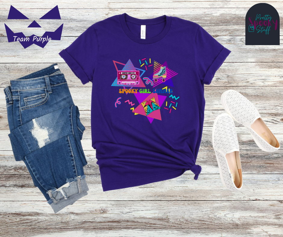 Summerween unisex tee featuring retro 90's design including cassette tape with "haunted house mix", bat covered roller skate, folded paper fortune teller, bright-colored squiggles, and words "spooky girl summer" across the middle in orange, green, and dark blue, in team purple.