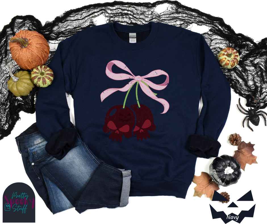 Coquette Halloween sweatshirt with two skull shaped cherries tied together with a large light pink bow, vintage style, in navy.