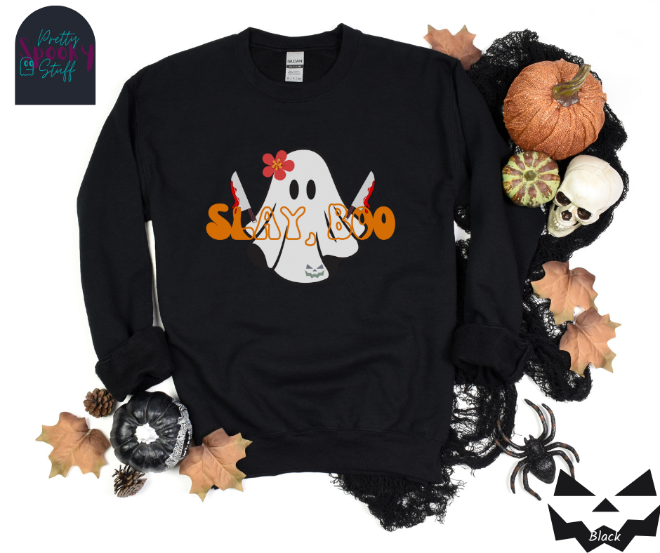 Ghost Halloween sweatshirt with a ghost wearing a pink flower on its head, holding two bloody knives, with the words "slay, boo" in orange vintage font in front, in black.