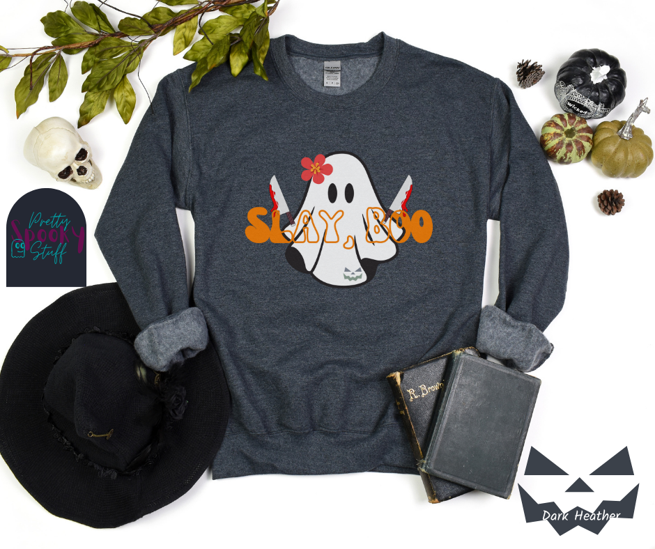 Ghost Halloween sweatshirt with a ghost wearing a pink flower on its head, holding two bloody knives, with the words "slay, boo" in orange vintage font in front, in dark heather.