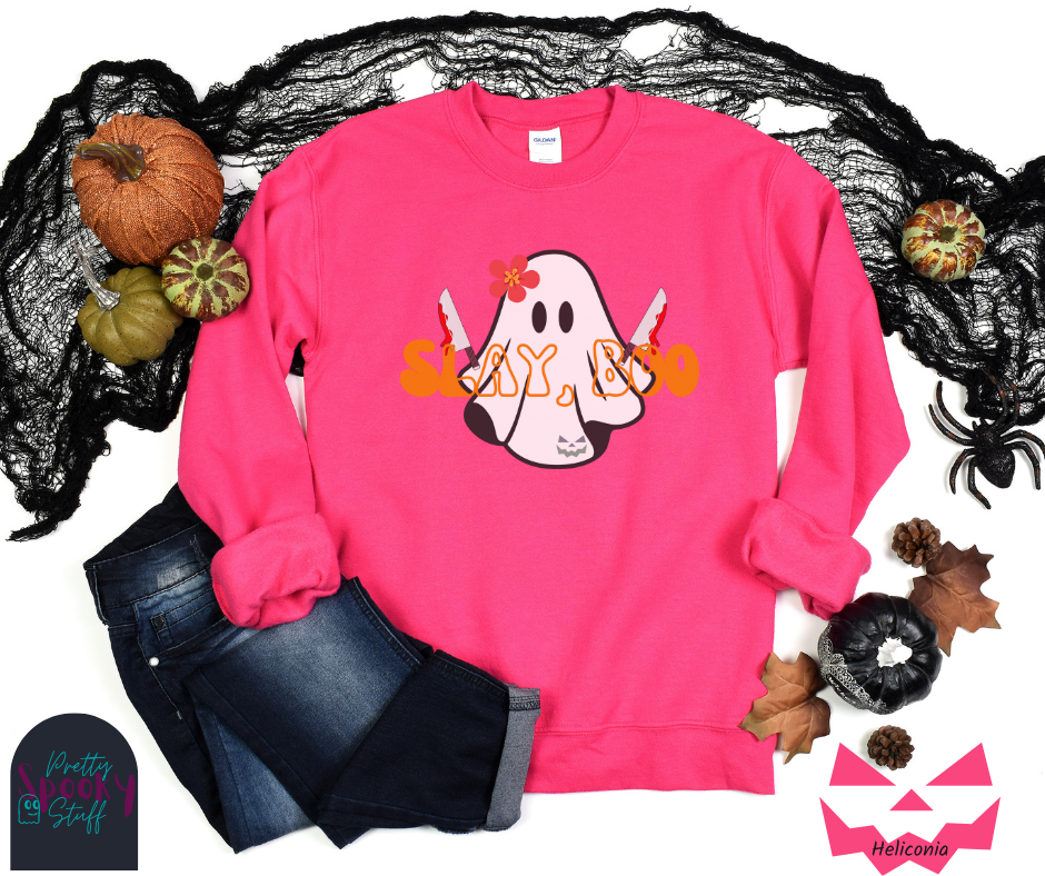Ghost Halloween sweatshirt with a ghost wearing a pink flower on its head, holding two bloody knives, with the words "slay, boo" in orange vintage font in front, in heliconia.