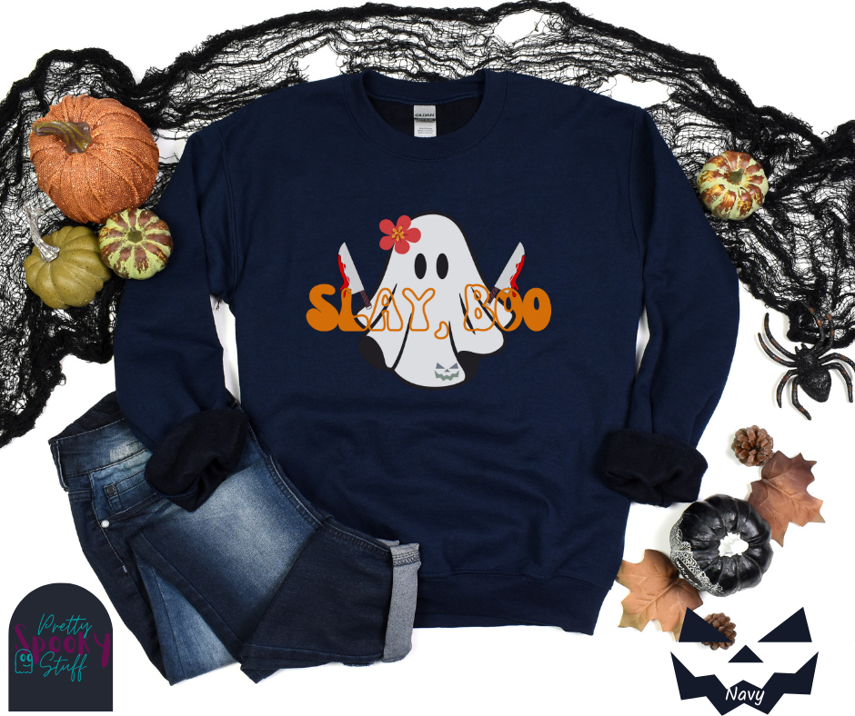 Ghost Halloween sweatshirt with a ghost wearing a pink flower on its head, holding two bloody knives, with the words "slay, boo" in orange vintage font in front, in navy.