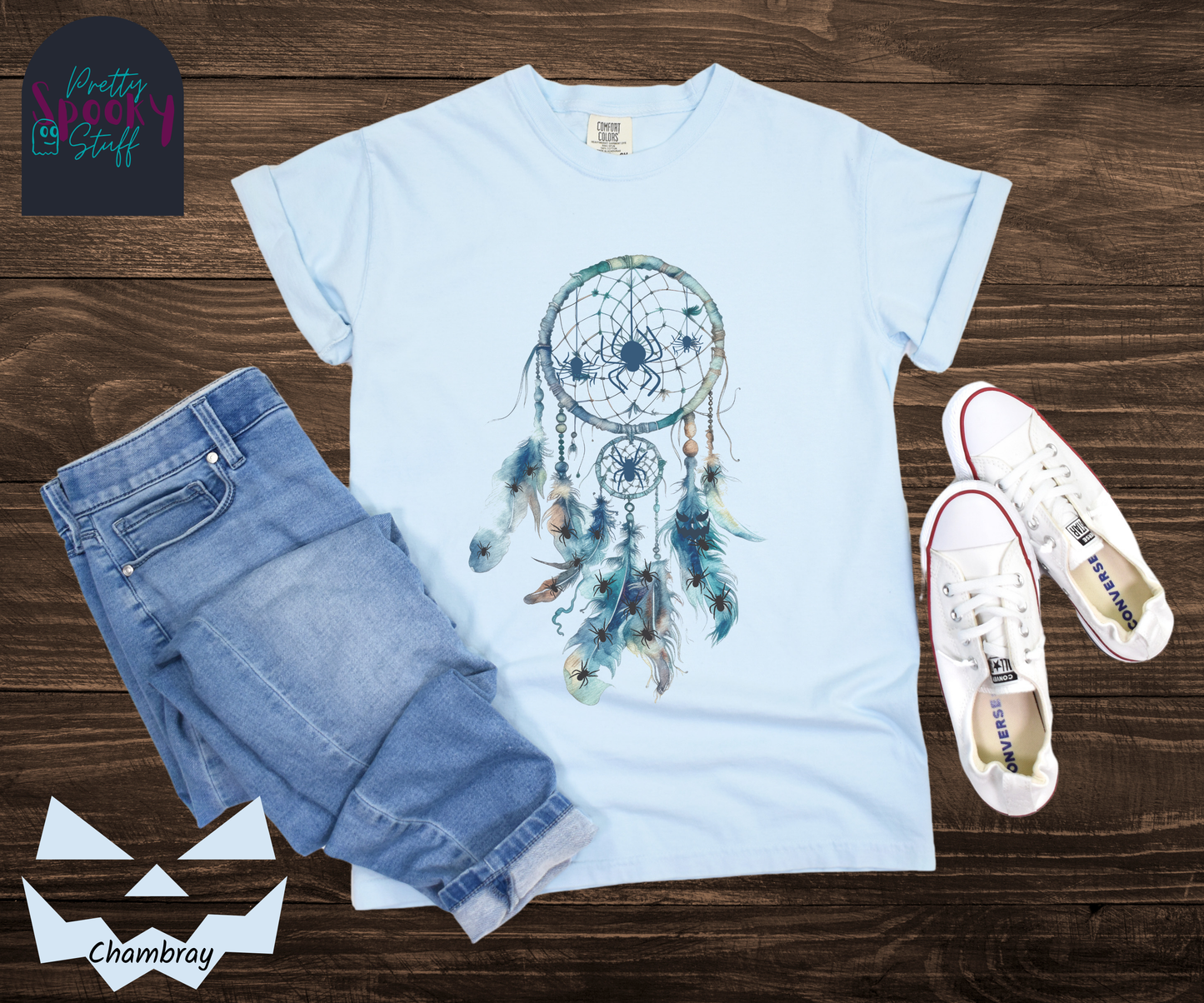 Halloween spider dreamcatcher shirt, watercolor aesthetic in shades of blue, a few spiders hanging in the main circle, several other spiders hiding in the multiple feathers hanging below, in chambray.