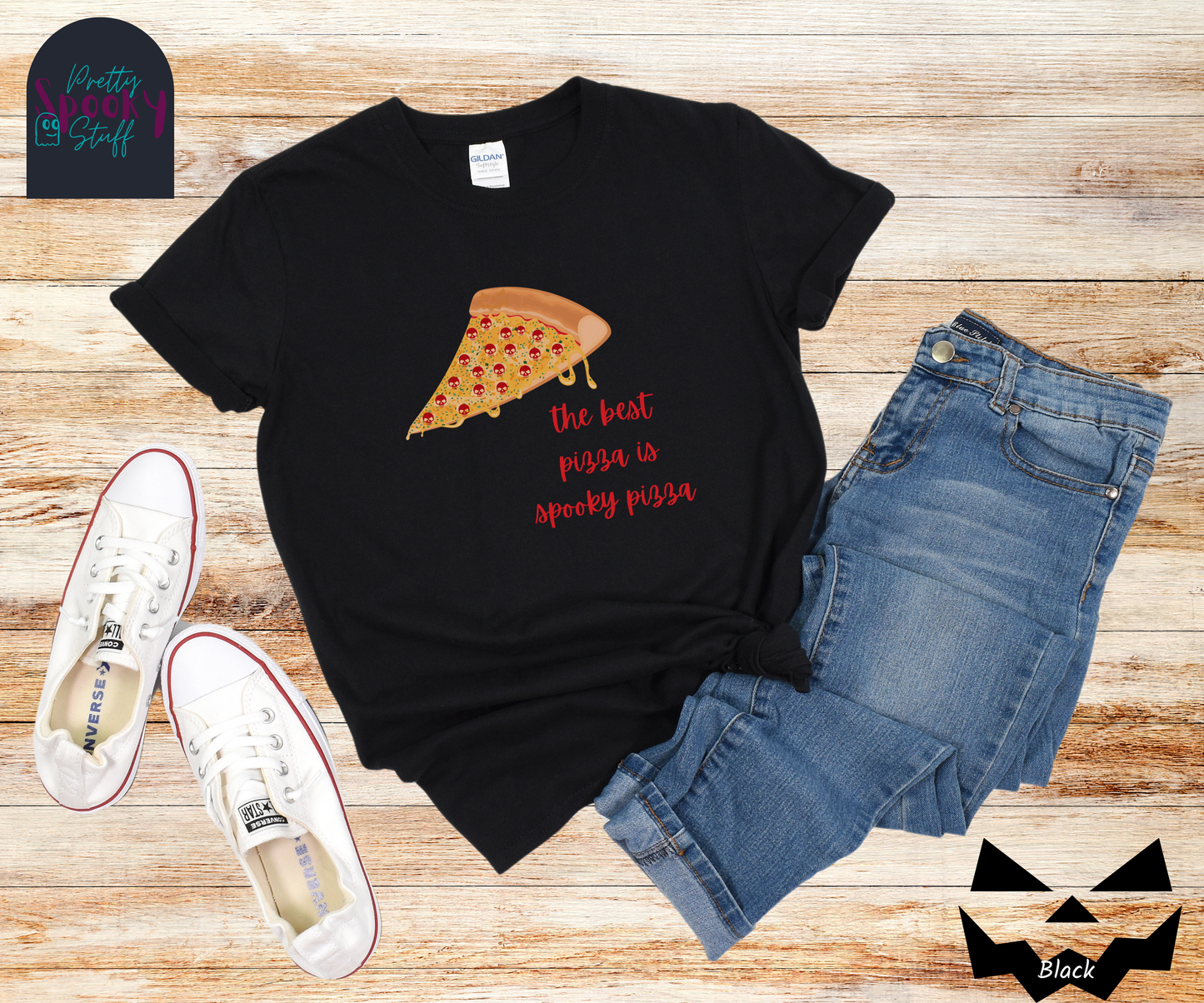 Pizza shirt with a slice of pepperoni pizza with skull shaped pepperonis and the words "the best pizza is spooky pizza" in red cursive font, in black.