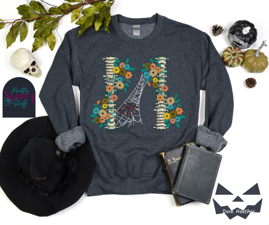 Spider Halloween sweatshirt with two spine bones wrapped in vintage flowers, and a tarantula spider on a web between the two, in dark heather.