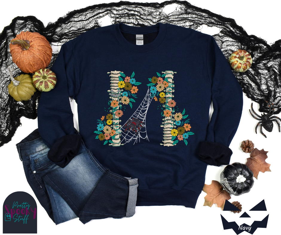 Spider Halloween sweatshirt with two spine bones wrapped in vintage flowers, and a tarantula spider on a web between the two, in navy