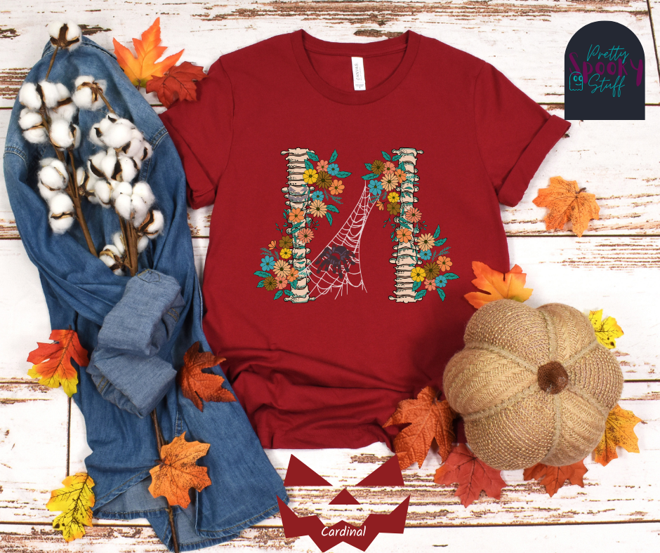 Spider Halloween shirt with two spine bones wrapped in vintage flowers, and a tarantula spider on a web between the two, in cardinal.