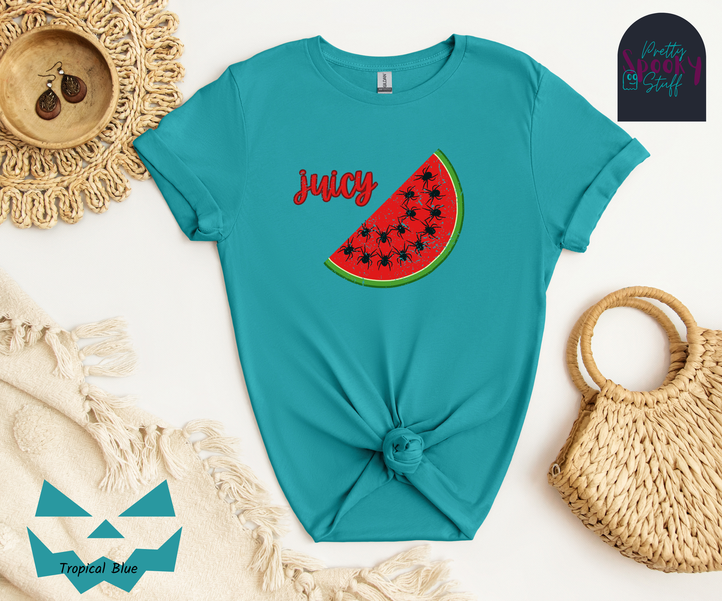 Summer watermelon shirt with a slice of watermelon where black spiders replace seeds, and the word "juicy" in red cursive font, vintage look, in tropical blue.