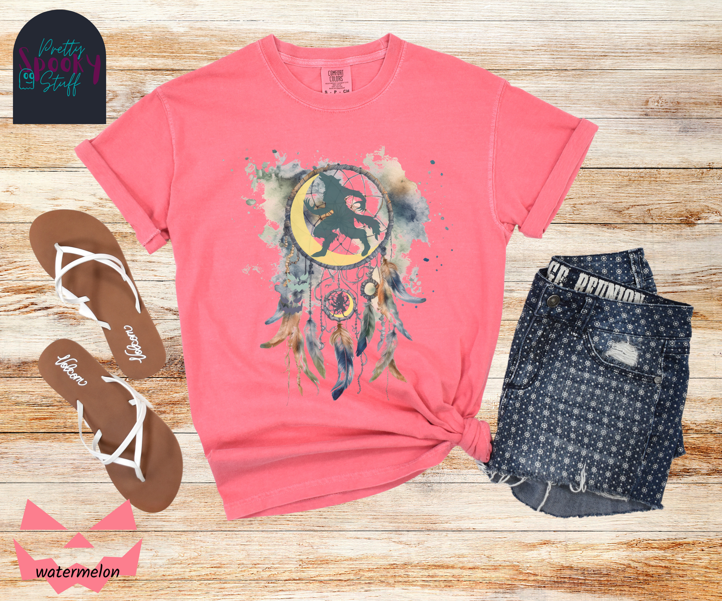 Halloween werewolf dreamcatcher shirt, watercolor aesthetic in blues and browns, featuring teal howling werewolf silhouette with yellow crescent moon in the main circle, with another werewolf/moon and jack o' lantern hiding amongst the several feathers and small circle hanging below, in watermelon.