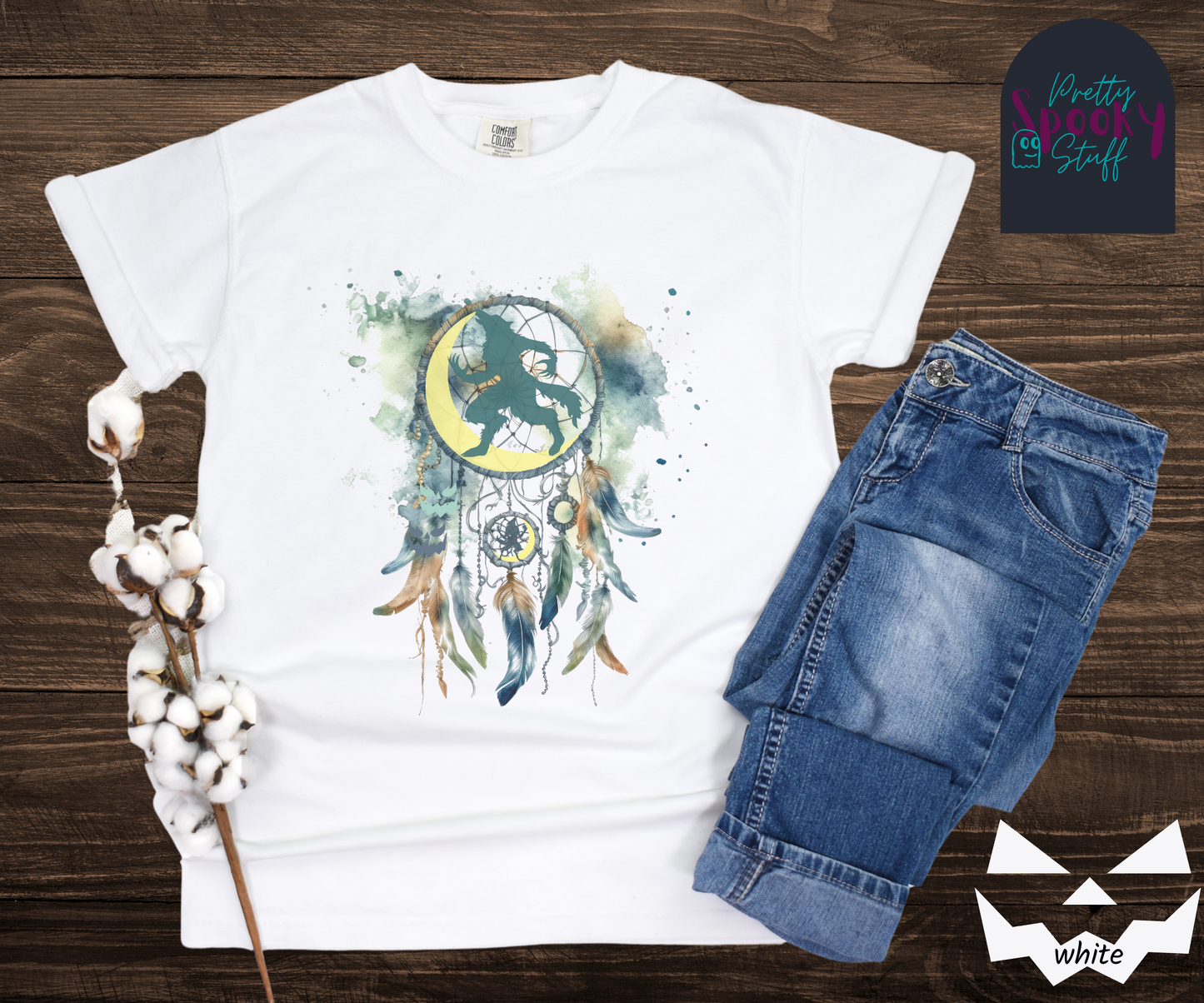 Halloween werewolf dreamcatcher shirt, watercolor aesthetic in blues and browns, featuring teal howling werewolf silhouette with yellow crescent moon in the main circle, with another werewolf/moon and jack o' lantern hiding amongst the several feathers and small circle hanging below, in white.