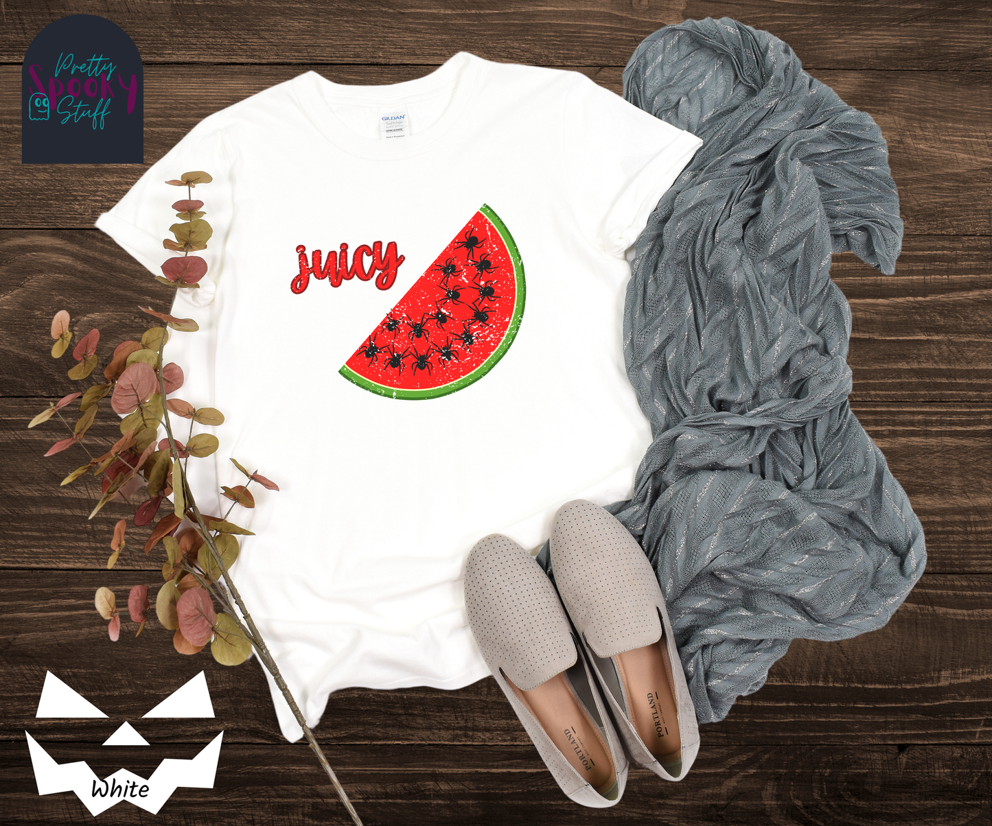 Summer watermelon shirt with a slice of watermelon where black spiders replace seeds, and the word "juicy" in red cursive font, vintage look, in white.