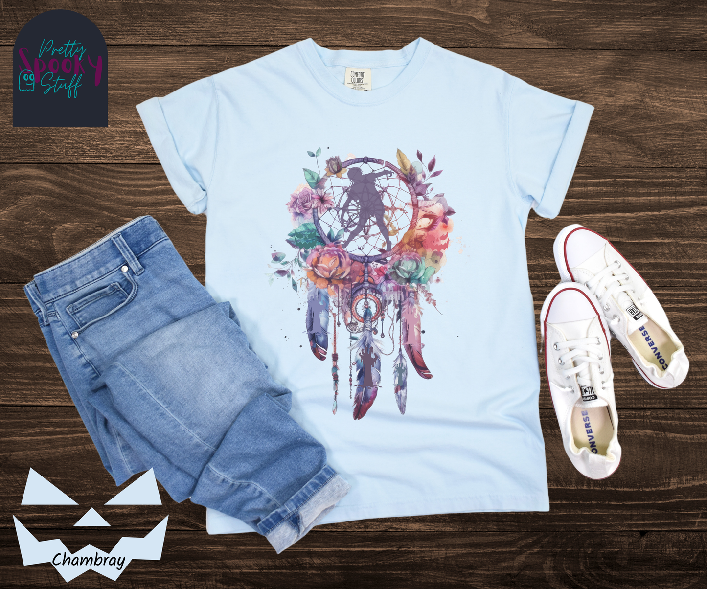 Zombie Halloween dreamcatcher shirt, watercolor aesthetic in purples, pinks, and teals, with purple zombie silhouette in the main circle, and zombie arm silhouettes hidden in the 3 feathers hanging below, in chambray.