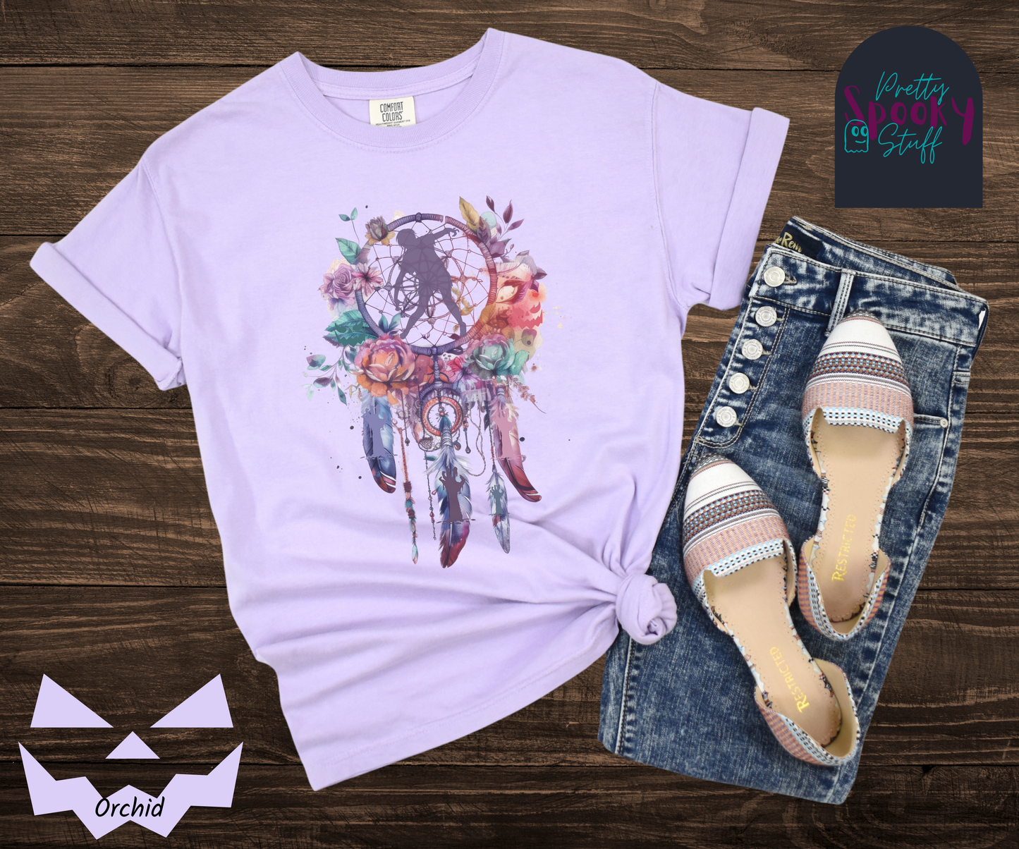 Zombie Halloween dreamcatcher shirt, watercolor aesthetic in purples, pinks, and teals, with purple zombie silhouette in the main circle, and zombie arm silhouettes hidden in the 3 feathers hanging below, in orchid.