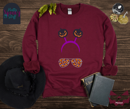 Halloween sweatshirt with aviator sunglasses filled with pumpkins and ghosts, and a purple headband with creepy jack o' lanterns, in maroon.