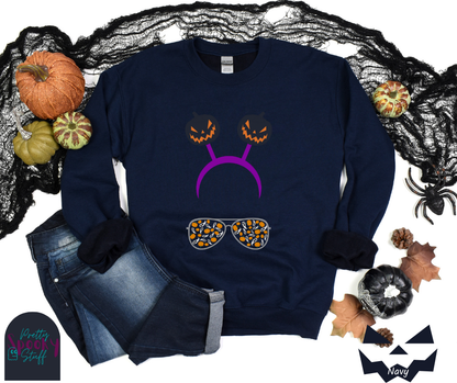 Halloween sweatshirt with aviator sunglasses filled with pumpkins and ghosts, and a purple headband with creepy jack o' lanterns, in navy.