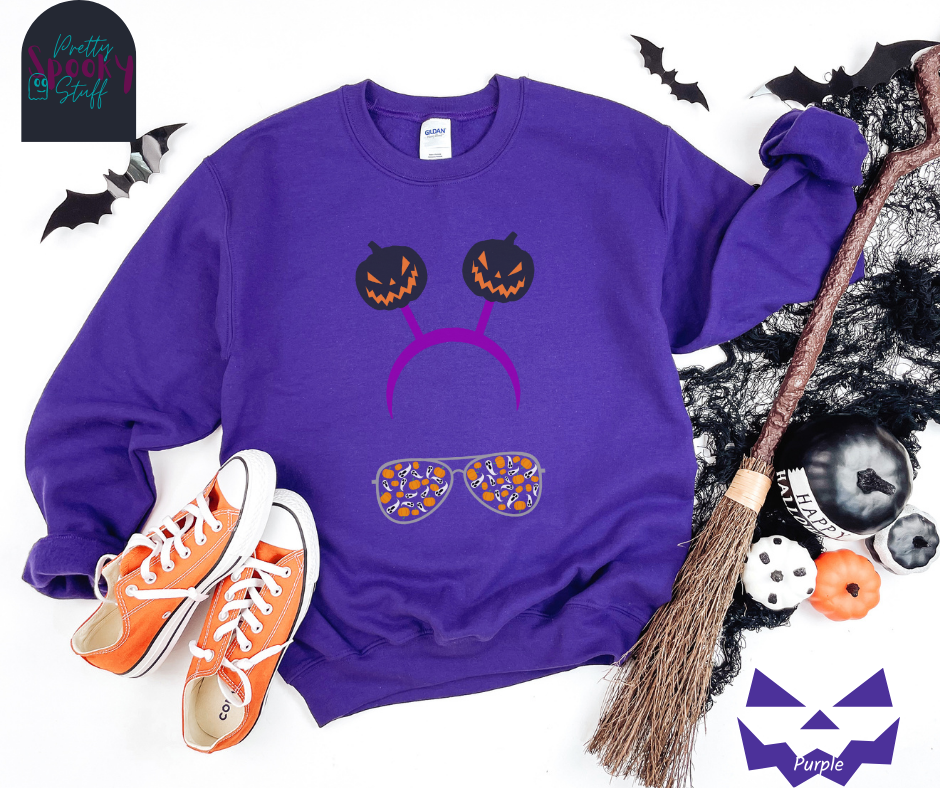 Halloween sweatshirt with aviator sunglasses filled with pumpkins and ghosts, and a purple headband with creepy jack o' lanterns, in purple.