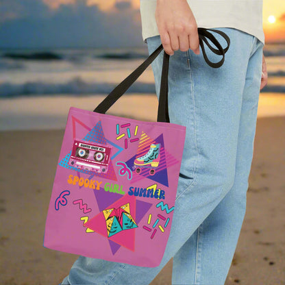 90's Style Summerween tote bag, magenta pink background with pink cassette tape with the words "haunted house mix" on it, rollerskate with bats, and skulls on the wheels, folded paper fortune teller, squiggles, and the words "spooky girl summer" across the middle in orange. green, and dark blue.