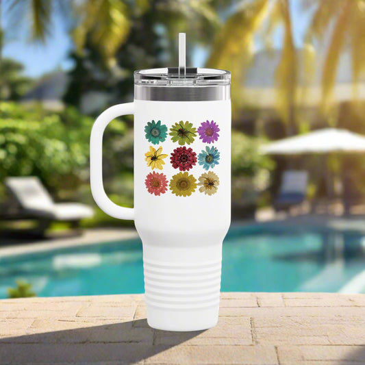 Spooky Girl Summer 40z tumbler with handle, lid, and straw, featuring 9 colorful daisies with three black widow spiders, and one web sitting on top of them, white background.