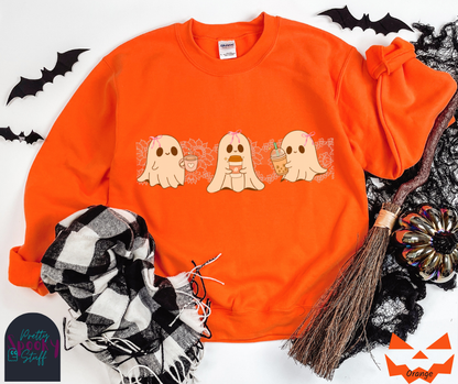 Coquette Halloween sweatshirt with three adorable ghosts, each enjoying their own coffee beverage, adorned with a pink bow, with light pink intricate lace design behind them, in orange.