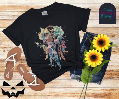 Gravestone dream catcher shirt, watercolor aesthetic dream catcher with blues, pinks and purples, 5 feathers hanging blow, mauve gravestones in main circle, and crescent moons hidden in feathers, in black.