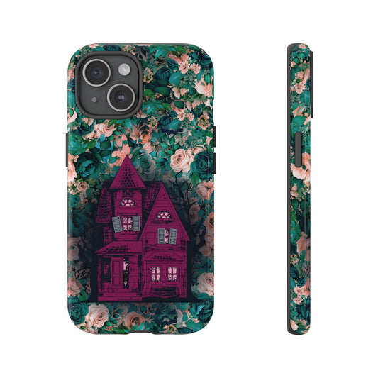 Haunted house Halloween iphone 15 pro max case with purple haunted house sitting on top of a rectangle bed of blue and pink flowers, in glossy.