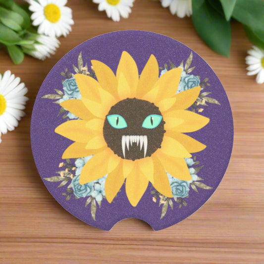 Spooky Girl Summer design featuring a sunflower with a menacing face in the middle(striking blue eyes and sharp teeth), with light blue florals in each corner, dark purple background. Sitting on wooden table surrounded by daisies.