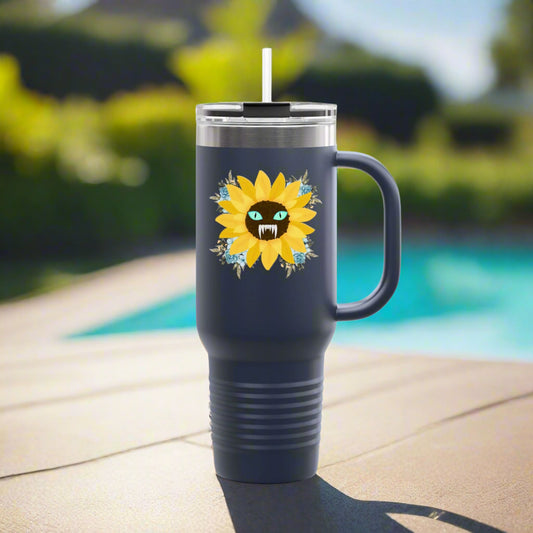 Spooky Girl Summer 40oz tumbler design featuring a sunflower with a menacing face in the middle(striking blue eyes and sharp teeth), with light blue florals in each corner, navy background. Sitting by the pool.
