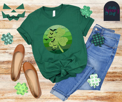 St. Patrick's Day shirt with circle green ombre lines behind light green four-leaf clover with bats flying up the left side, vintage style, in evergreen.