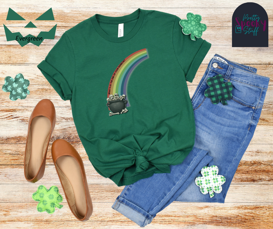 St. Patrick's Day shirt with a half rainbow coming out of a cauldron filled with bones, with the words "what's at the end of your rainbow" following the curve of the red line, in evergreen.