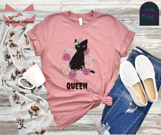 Spooky Girl Summer unisex tee featuring regal black cat sitting in the middle of a ring of purple and pink roses, wearing a crooked crown, with the word "queen" below, on heather mauve.
