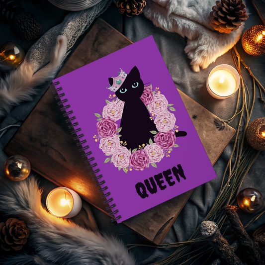 Spooky Girl Summer spiral notebook featuring black cat sitting in ring of pink and purple roses, wearing a crooker crown with the word "queen" below in black, with purple background.
