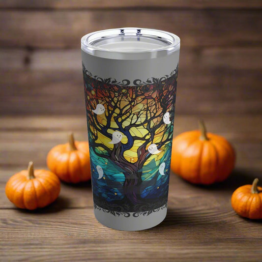 20 ounce insulated tumbler with stained glass design featuring a bare tree reaching upwards and ghosts flying all around.