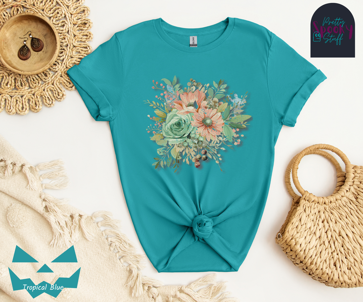 Floral shirt with a bouquet of flowers in pastel color scheme, and mummies hiding among the outlying leaves, in tropical blue.