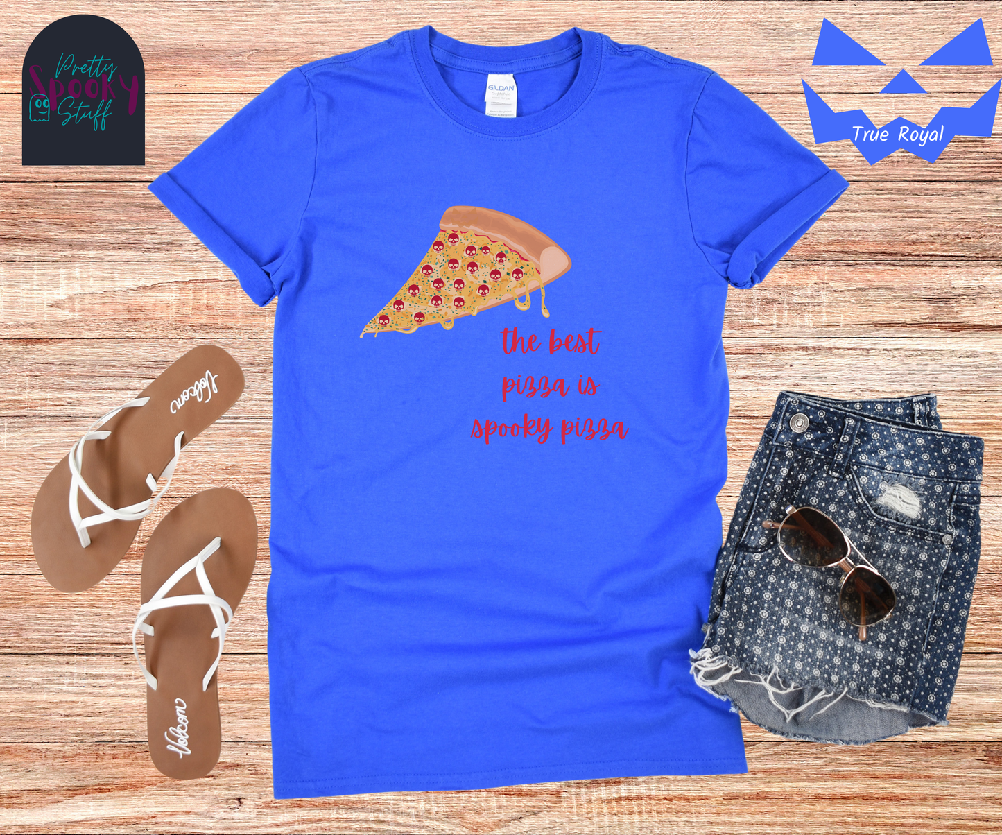 Pizza shirt with a slice of pepperoni pizza with skull shaped pepperonis and the words "the best pizza is spooky pizza" in red cursive font, in true royal.