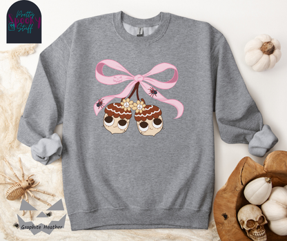 Fall coquette vintage shirt with large pink bow that ties twin acorn characters together, two spiders on the bow, acorns having cutesy faces, in graphite heather.