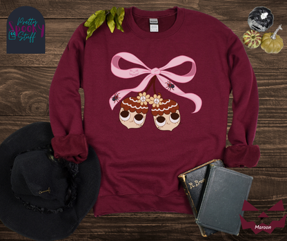 Fall coquette vintage shirt with large pink bow that ties twin acorn characters together, two spiders on the bow, acorns having cutesy faces, in maroon.
